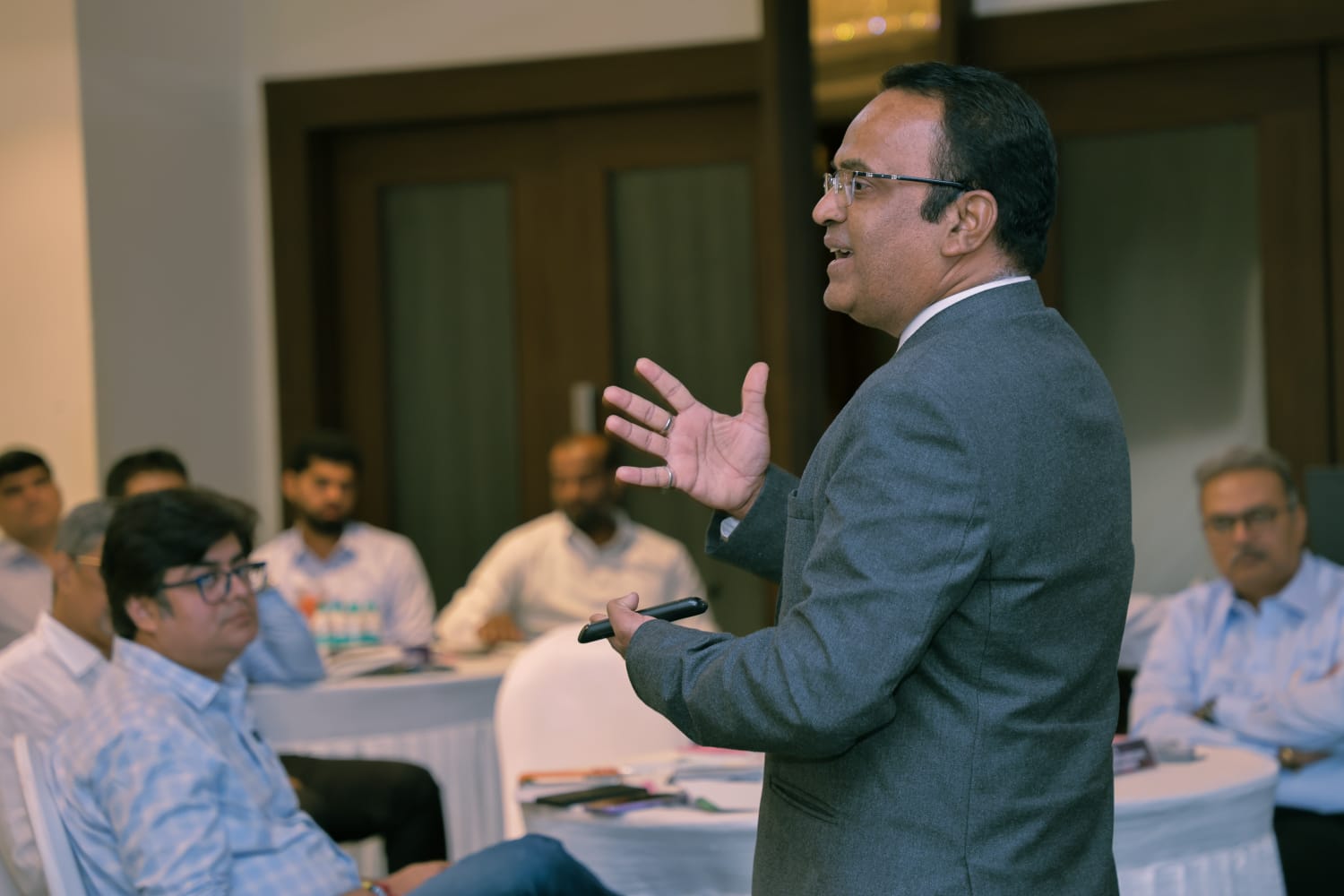 Coach Dr. Nitin Rishi addressing participants during a training session